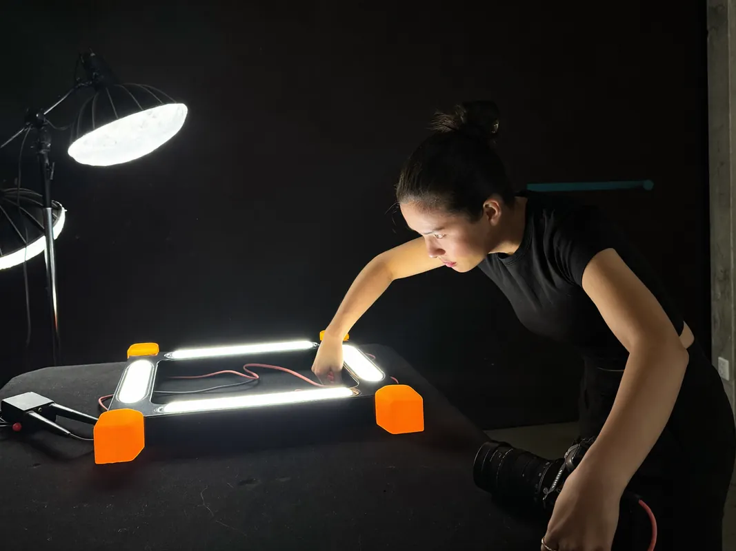 AI concept image: a photographer setting up an industrial LED light fixture in a studio